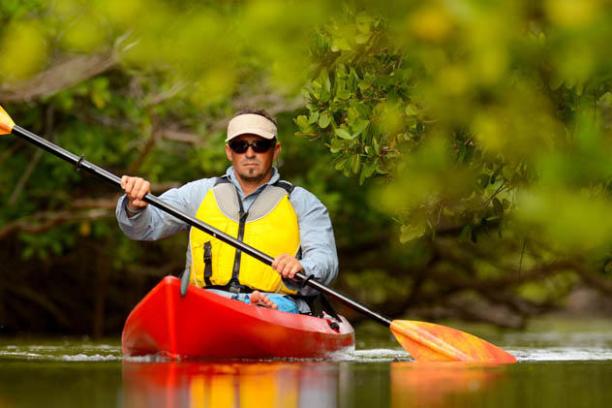 Man riding in a kayak in the mangrove forest